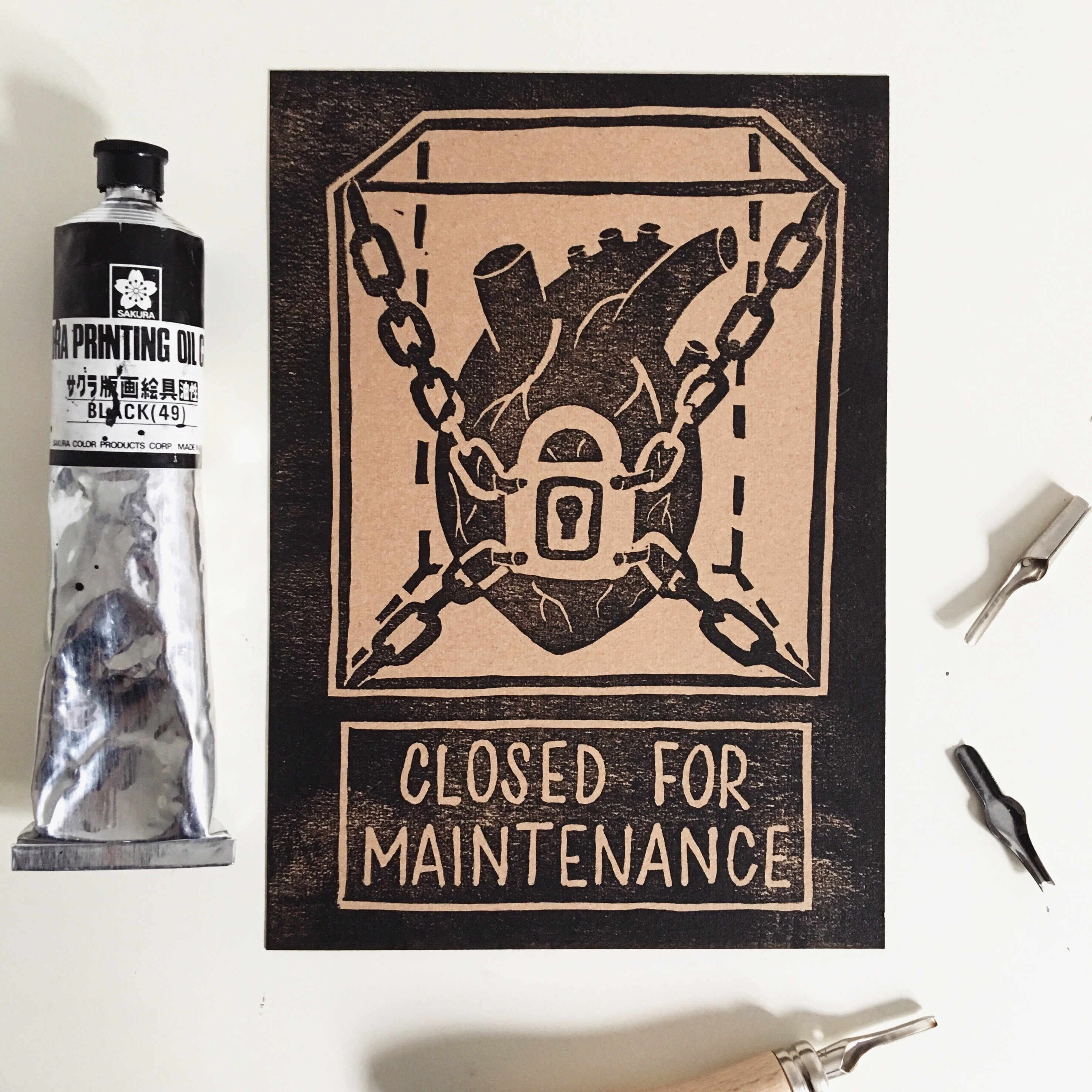 Linocut print. Heart and a sign "closed for maintenance"