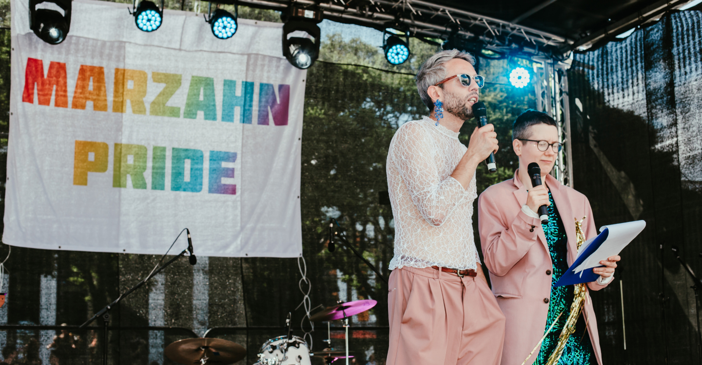 Marzahn pride stage, 2 people speaking on the microphone